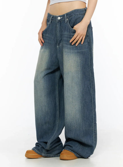 Jesse Vintage Wash Wide Leg Jeans CU530 Blue side view on model, hand in pocket, extra-wide leg silhouette with light fading, styled with white belt