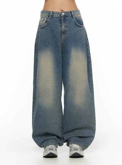 LEWKIN Jiya Washed Wide Leg Jeans CL503 Blue front view on model cropped at waist showing faded wash wide-leg silhouette with button closure and sneakers