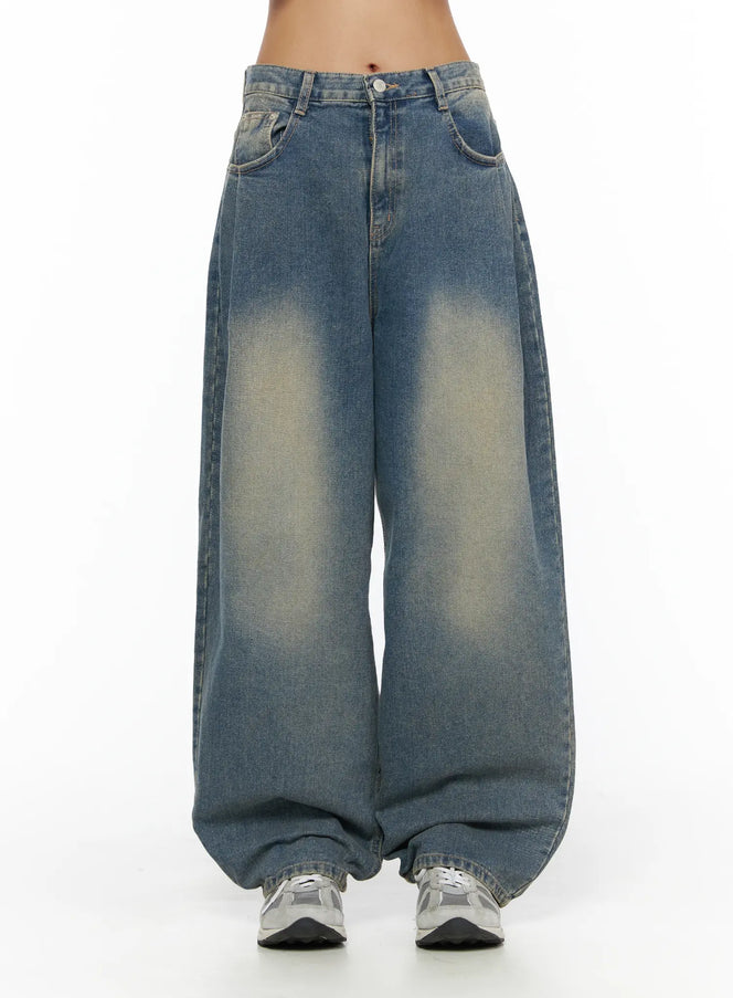 LEWKIN Jiya Washed Wide Leg Jeans CL503 Blue front view on model cropped at waist showing faded wash wide-leg silhouette with button closure and sneakers