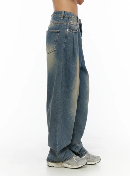 Jiya Washed Wide Leg Jeans CL503 Blue side view cropped at waist on model showing pleated waistband side pocket and yellow faded wash texture
