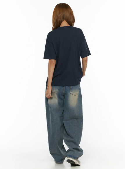 Jiya Washed Wide Leg Jeans CL503 Blue back view on model with navy tee showing rear pockets and faded wash detail on oversized wide-leg denim