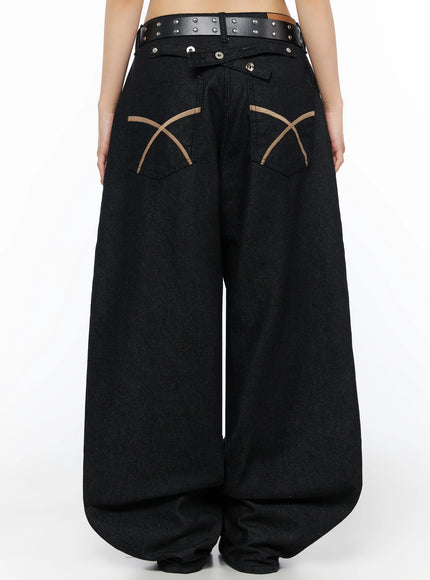 Kairo Back Buckle Wide Jeans IL515 Black back view close-up on model showing tan X-cross embroidered back pockets, snap button waistband, and studded belt detail