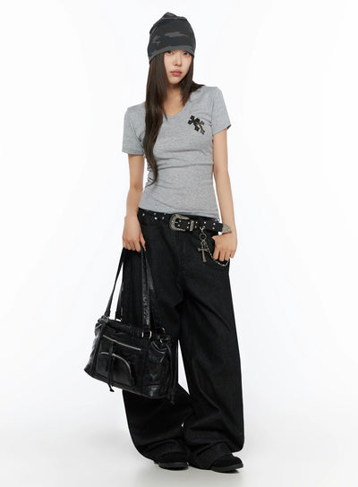 Kairo Back Buckle Wide Jeans IL515 Black full-length front view on model wearing gray tee and camo beanie, holding black leather bag, studded western belt with cross charm