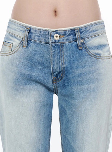 Keilani Low-Rise Bootcut Jeans IL502 Blue close-up detail of low-rise waistband, contrast stitching, button fly, front pockets, faded denim texture