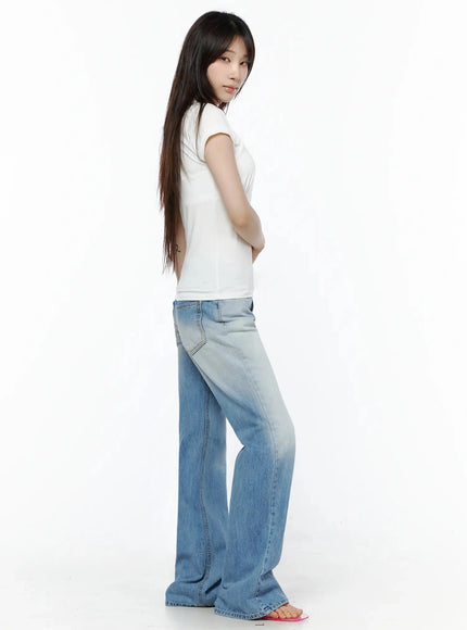Keilani Low-Rise Bootcut Jeans IL502 Blue side-back shot on model in white tee, arms crossed, showing flare silhouette and back pocket placement