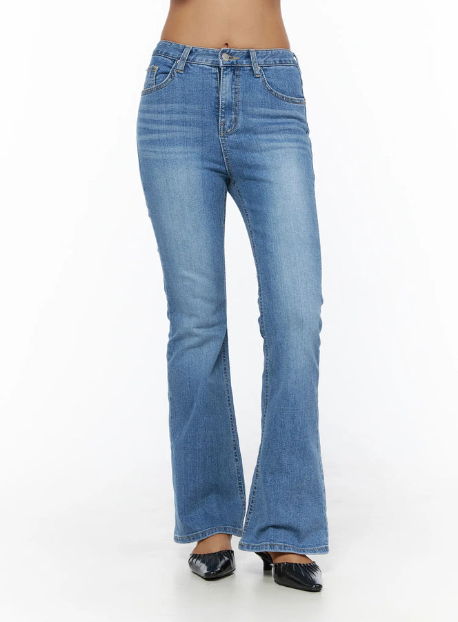 Kerry Washed Bootcut Jeans CL503 Blue front view on model standing showing mid-rise waist button fly and flared bootcut leg washed denim