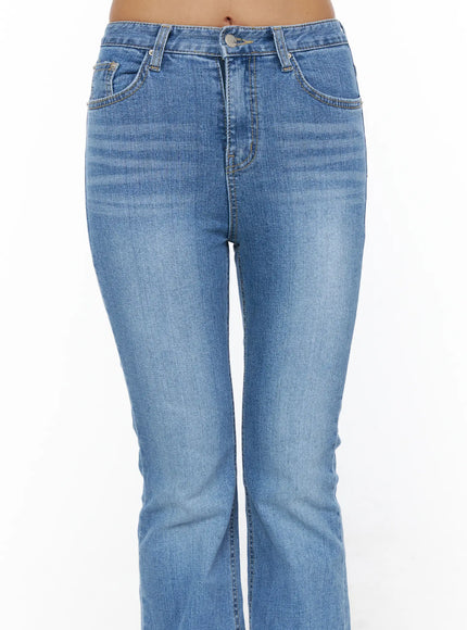 Kerry Washed Bootcut Jeans CL503 Blue close-up front detail shot on model showing mid-rise waistband button fly side pockets and washed denim texture