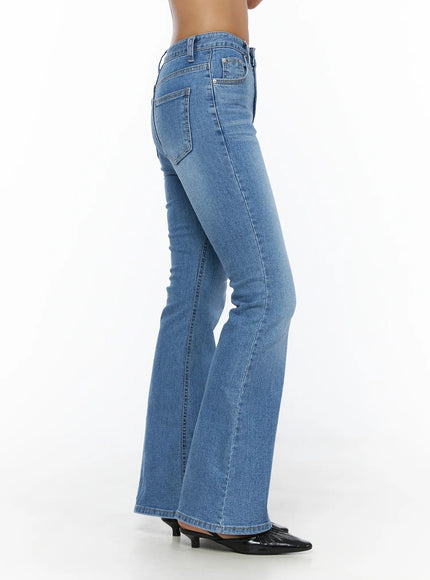 Kerry Washed Bootcut Jeans CL503 Blue side view on model standing showing slim thigh silhouette flaring into bootcut hem washed denim
