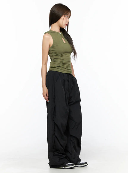 Keyhole Button Hooded Crop Sleeveless Top CL514 Dark green side model shot showing keyhole button neckline and ruched waist ribbed knit styled with black cargo pants