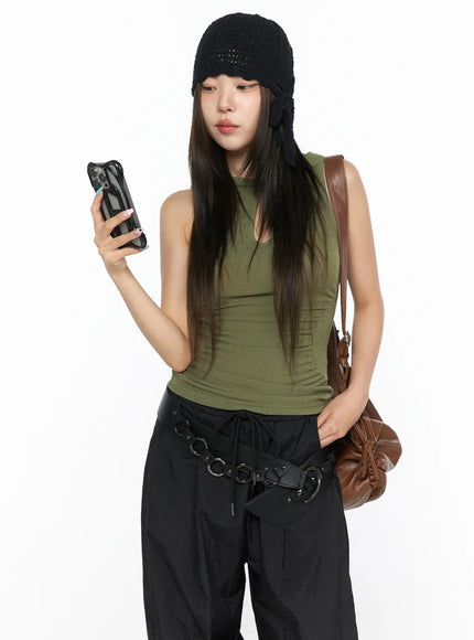 LEWKIN Keyhole Button Hooded Crop Sleeveless Top CL514 Dark green front model shot holding phone styled with black cargo pants and knit hat