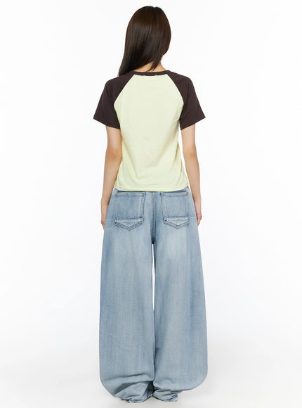 Kit Washed Wide Leg Jeans IL523 Light blue back full-length view on model with raglan tee, showing dual patch back pockets and wide leg denim silhouette