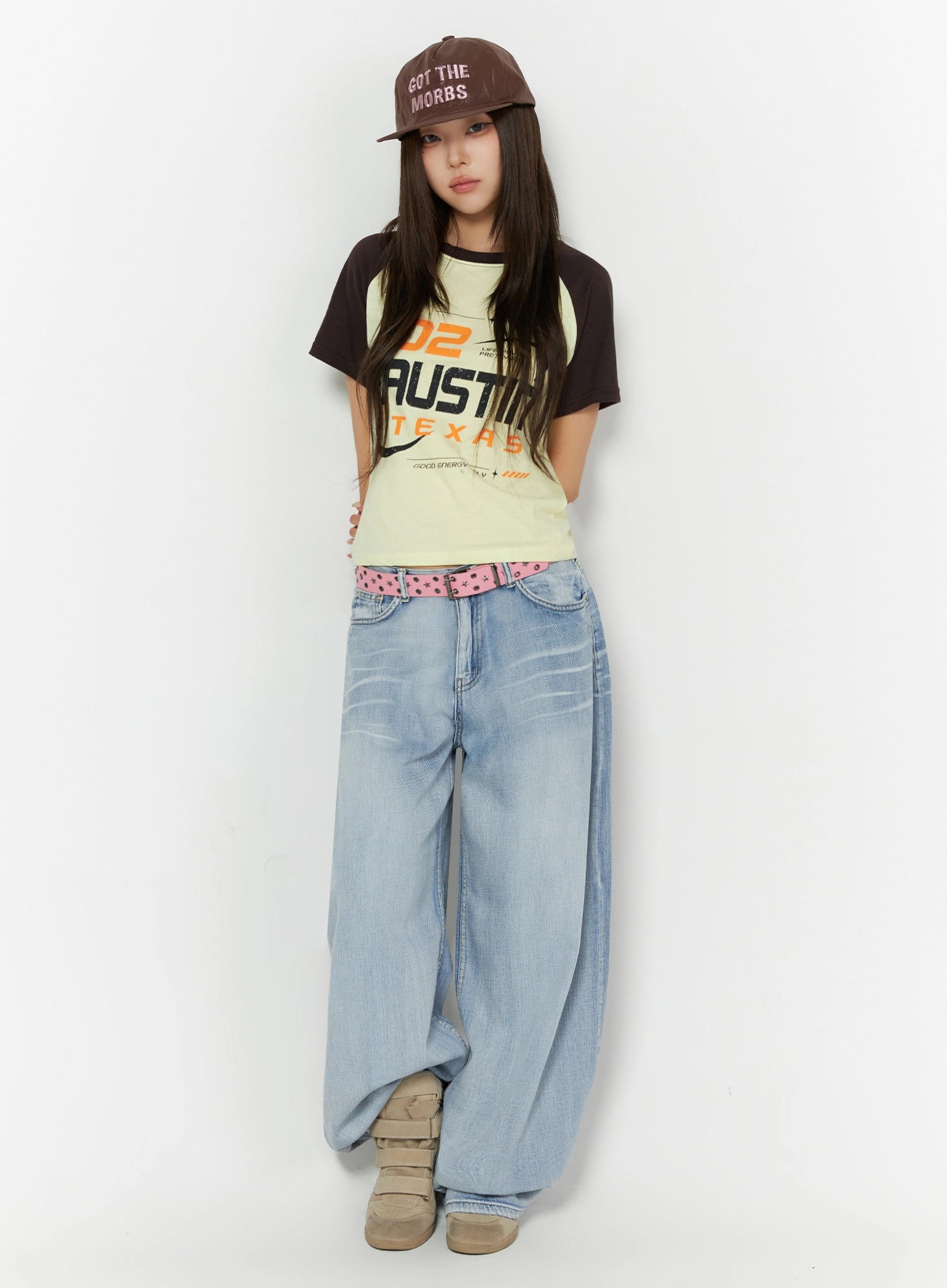 Kit Washed Wide Leg Jeans IL523 Light blue full front view on model wearing cap, front-facing pose, pink studded belt, wide balloon leg washed jeans