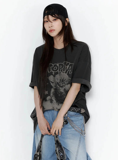 LEWKIN Kitty Graphic Oversize T-Shirt IL506 Dark gray front shot on model wearing black cap, paired with blue wide-leg jeans, vintage washed cotton