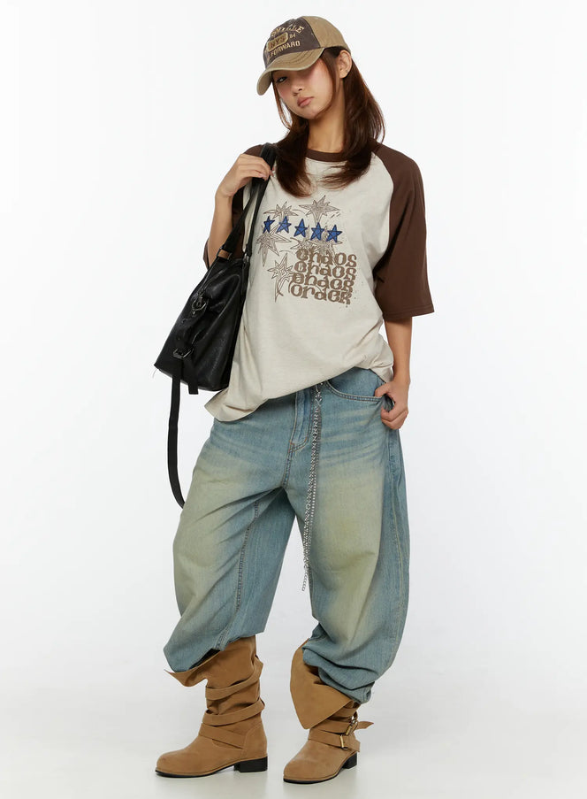 Kiva Washed Wide-Leg Jeans CL515 Light blue full-body styling shot on model wearing graphic raglan tee, cap, and boots with chain detail accent