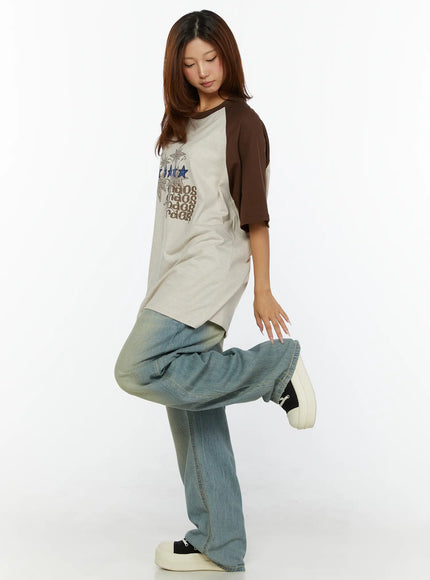 Kiva Washed Wide-Leg Jeans CL515 Light blue side styling shot on model lifting one leg, showing voluminous balloon leg shape and oversized denim drape