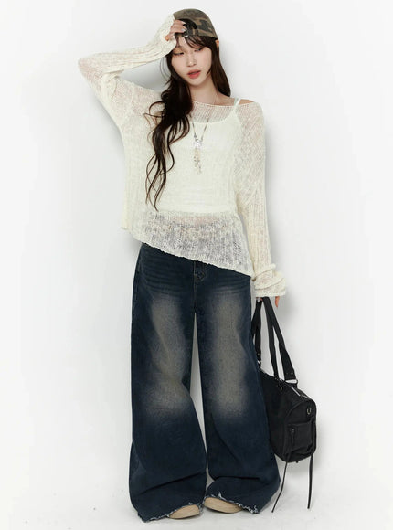Knit Boat Neck Sweater IL506 Light beige full-body front shot on model touching camo cap, one hand raised, black bag at side, sheer open-knit, wide-leg jeans, S/M