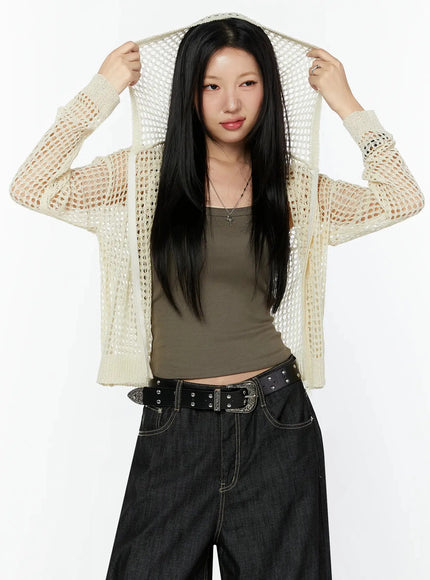 Knit Net Zip-Up Hoodie IL516 Light beige front shot on model pulling hood up with both hands, large open-knit mesh hood detail highlighted, styled with khaki tank