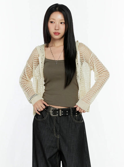 Knit Net Zip-Up Hoodie IL516 Light beige front shot on model hands on hips looking aside, open-weave mesh fabric with ribbed hood and cuffs over khaki tank and wide-leg denim