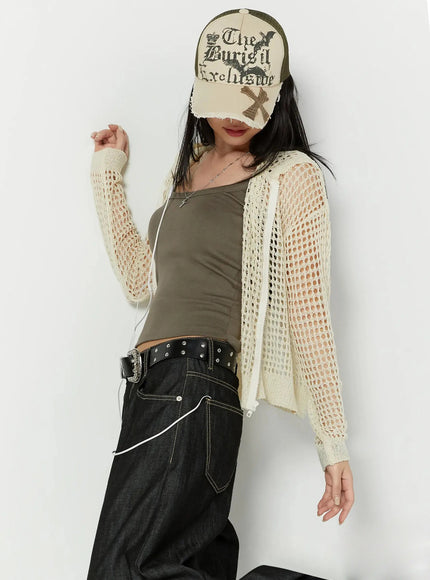 LEWKIN Knit Net Zip-Up Hoodie IL516 Light beige S/M front shot on model wearing cap, open mesh crochet texture layered over khaki tank with dark wide-leg jeans