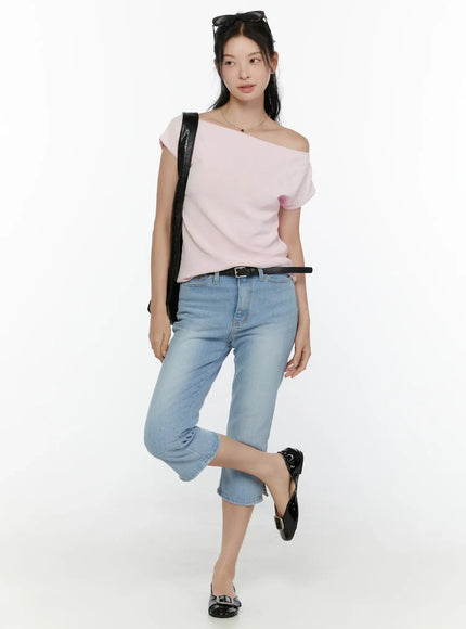 Knit Off-Shoulder Top CL521 Pink full-body front shot on model with blue cropped jeans, black flats and bag, playful one-leg pose