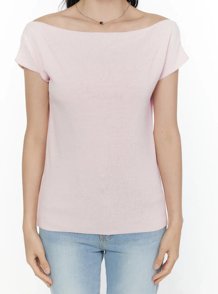 Knit Off-Shoulder Top CL521 Pink close-up detail front shot on model highlighting asymmetric off-shoulder neckline and fine knit fabric structure