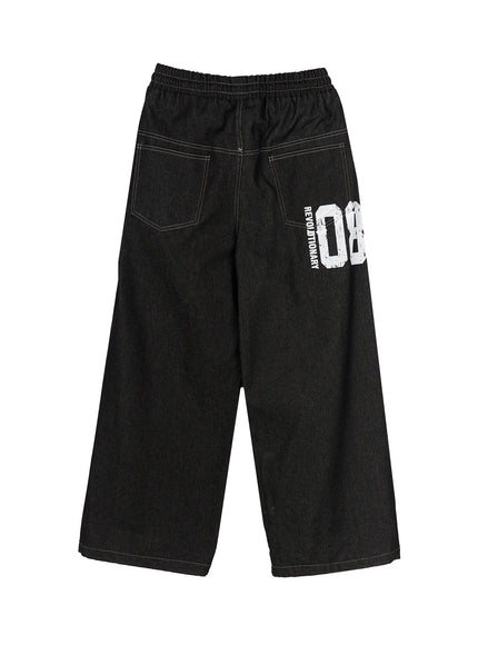Kris Back Graphic Baggy Jeans IL524 Black flat-lay back view showing back patch pockets REVOLUTIONARY 08 distressed white graphic print contrast stitching and wide hem