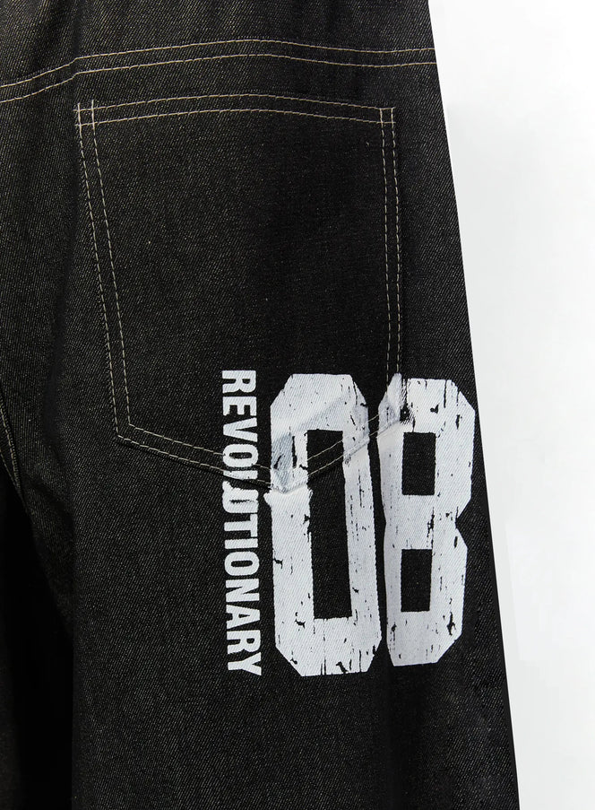 Kris Back Graphic Baggy Jeans IL524 Black close-up detail of back leg showing REVOLUTIONARY 08 distressed white graphic print on dark denim with contrast stitching
