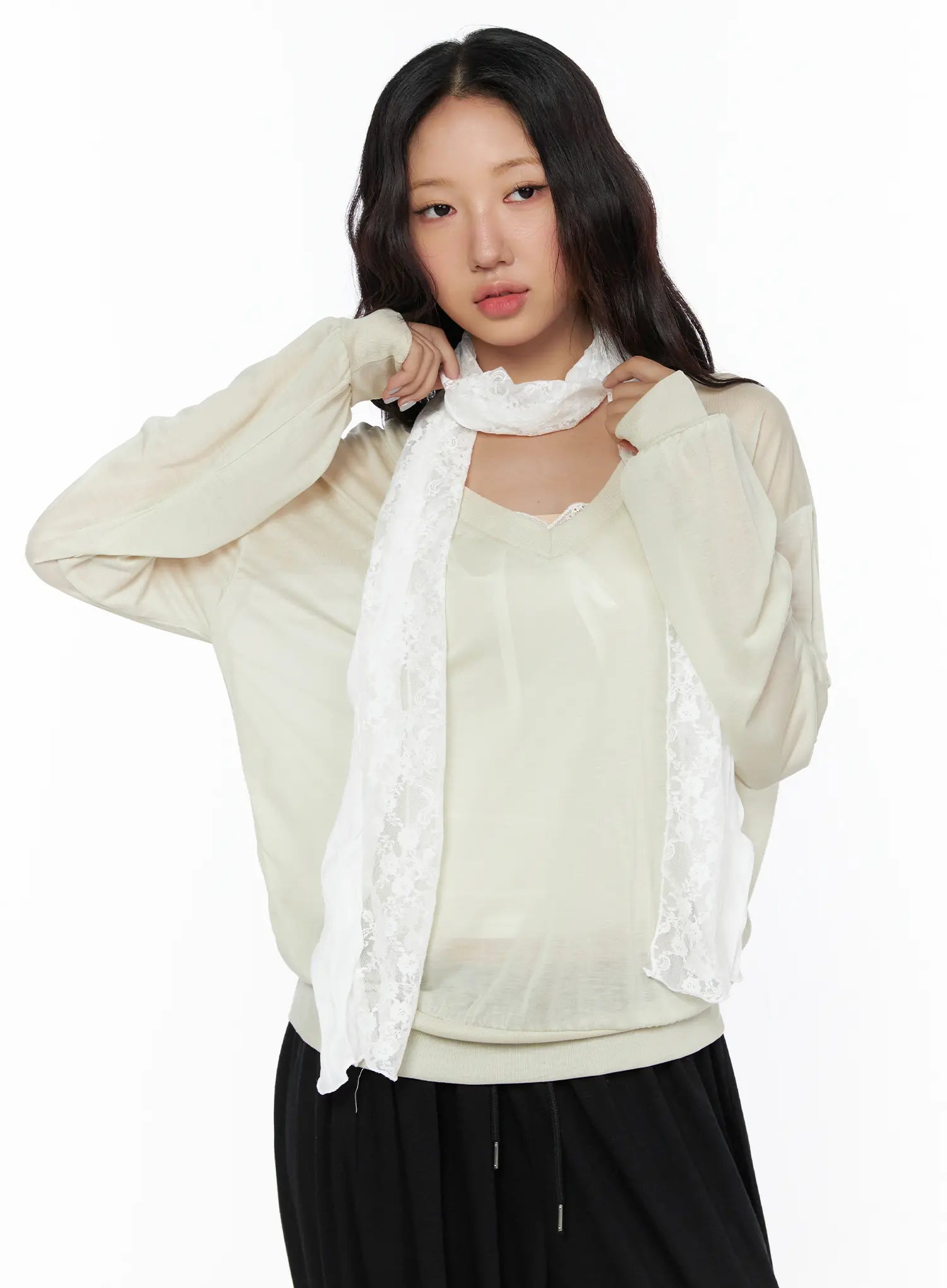 Lace Accent Sheer Scarf CL513 White front shot on model adjusting scarf at neckline styled with beige sheer top and black drawstring pants