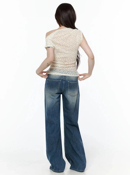 Lace Asymmetrical Off-Shoulder Top IL506 Light beige back shot on model showing sheer lace panel asymmetric shoulder detail hands on waistband of jeans