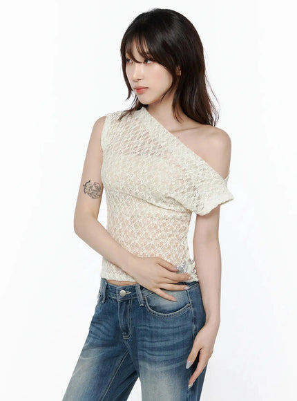 Lace Asymmetrical Off-Shoulder Top IL506 Light beige half-body side shot on model hand on waist highlighting asymmetric off-shoulder neckline and sheer lace detail