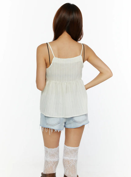 Lace Babydoll Top CL515 Light beige back model shot, showing open back with spaghetti straps, gathered peplum seam, sheer pinstripe fabric from behind