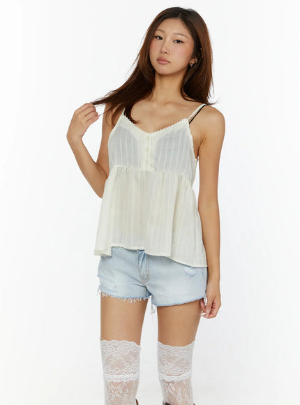 Lace Babydoll Top CL515 Light beige close-up front detail, scallop lace neckline, center button placket, sheer pinstripe fabric texture and gathered waist seam