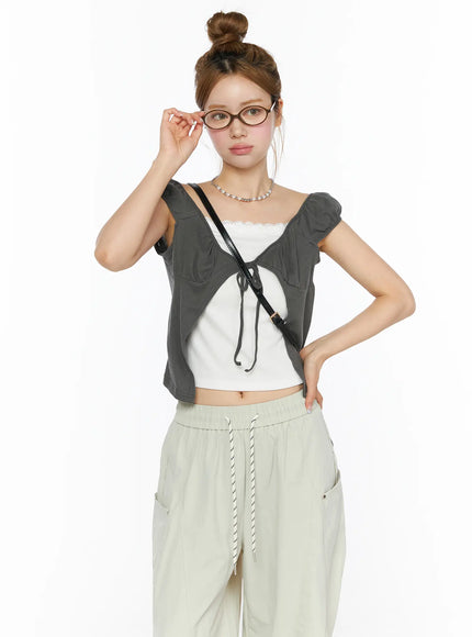 LEWKIN Lace Cami Tie-Front Puff Sleeve Blouse CL501 Dark gray front shot on model size S/M styled with glasses and crossbody bag over white lace cami