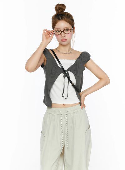 LEWKIN Lace Cami Tie-Front Puff Sleeve Blouse CL501 Dark gray front shot on model size S/M styled with glasses and crossbody bag over white lace cami