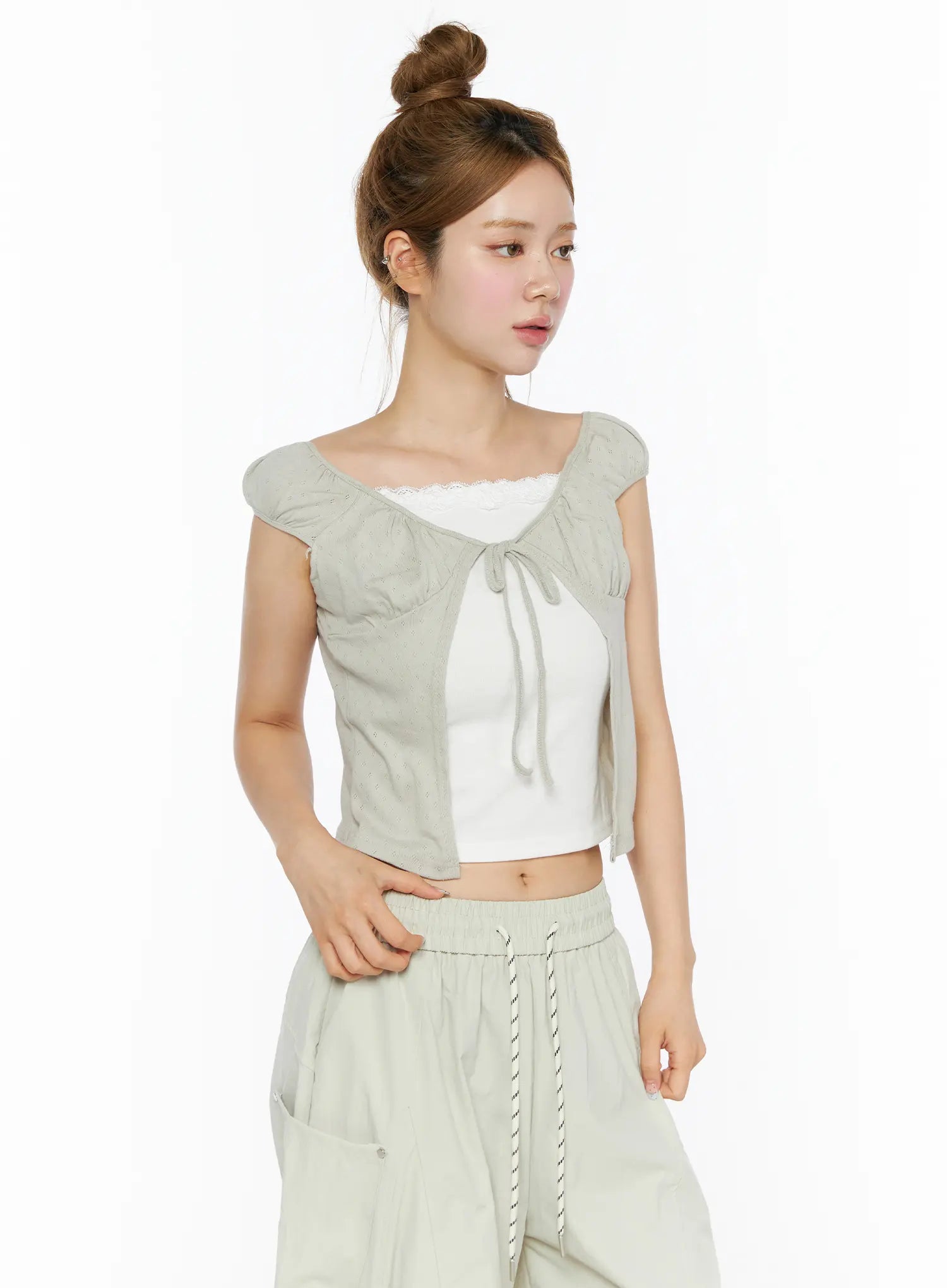 Lace Cami Tie-Front Puff Sleeve Blouse CL501 Light sage green three-quarter side shot on model layered over white lace cami with wide-leg pants