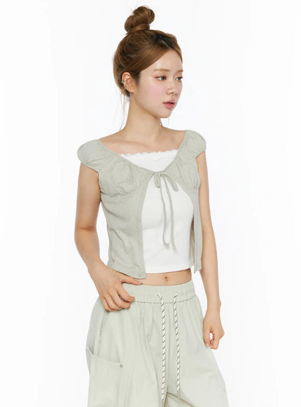 Lace Cami Tie-Front Puff Sleeve Blouse CL501 Light sage green three-quarter side shot on model layered over white lace cami with wide-leg pants