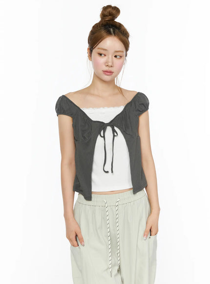 Lace Cami Tie-Front Puff Sleeve Blouse CL501 Dark gray upper-body front shot on model size S/M gazing aside showing tie-front detail layered over white lace cami