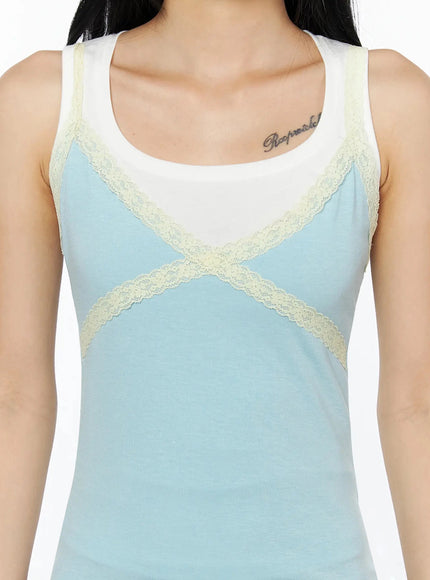 Lace Contrast Cami Top IL509 Light blue close-up detail shot on model showing cream lace X-cross trim and color-block white and blue paneling