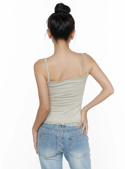Lace Detail Cami Top CL513 Beige back view on model showing thin spaghetti straps, open back ribbed fabric and scalloped lace hem trim with jeans