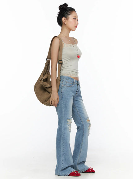Lace Detail Cami Top CL513 Beige side view on model with bun updo and crossbody bag styled with ripped flare jeans, showing fitted silhouette and lace hem
