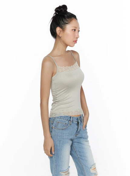 Lace Detail Cami Top CL513 Beige side shot on model showing fitted ribbed body, thin spaghetti straps, lace chest trim and scalloped lace hem with jeans