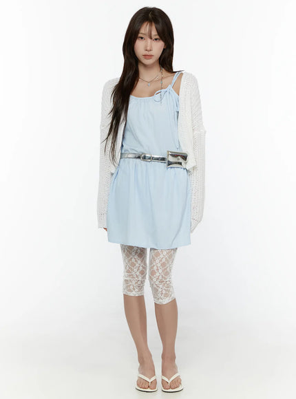 Lace Detail Capri Leggings CL508 White front view on model standing upright styled with blue cami mini dress white knit cardigan and silver waist bag with flip-flops