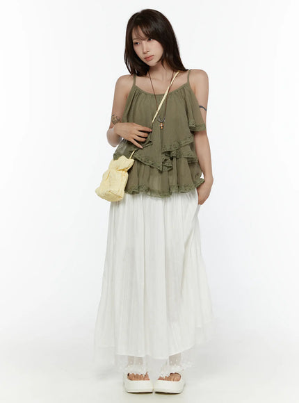 LEWKIN Lace Flared Maxi Skirt CL507 white front shot on model standing upright styled with olive ruffle cami top and yellow crossbody bag
