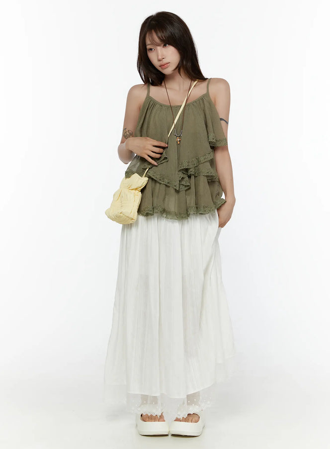 LEWKIN Lace Flared Maxi Skirt CL507 white front shot on model standing upright styled with olive ruffle cami top and yellow crossbody bag
