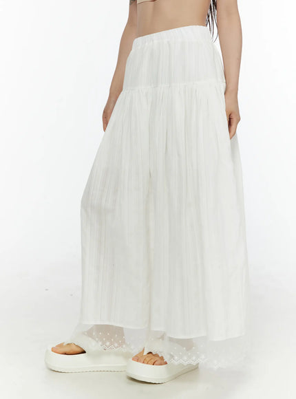 Lace Flared Maxi Skirt CL507 white side shot on model showing tiered pleated silhouette with sheer lace hem and platform sandals