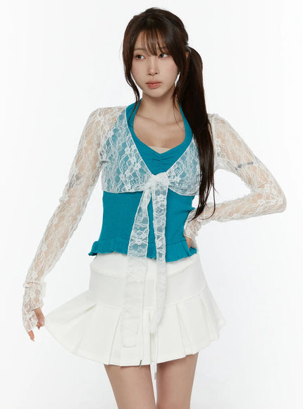 LEWKIN Lace Front-Tie Bolero CL507 White S/M front shot on model wearing teal ribbed top and white pleated mini skirt, sheer floral lace fabric