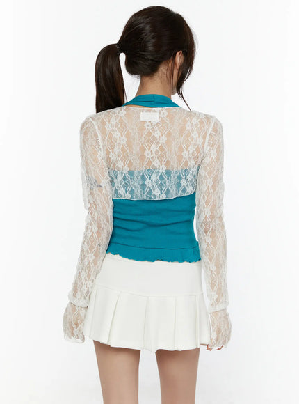 Lace Front-Tie Bolero CL507 White back shot on model showing sheer floral lace back panel over teal inner top with ruffled hem and white pleated skirt