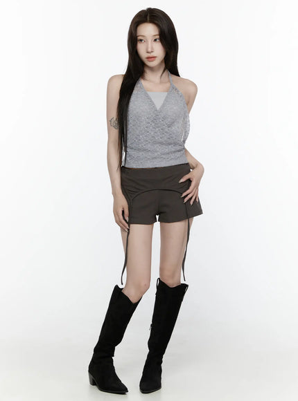 Lace Halter-Neck Top IL522 Gray front shot model standing upright wearing gray lace wrap halter top with dark mini shorts and black knee-high boots on white background