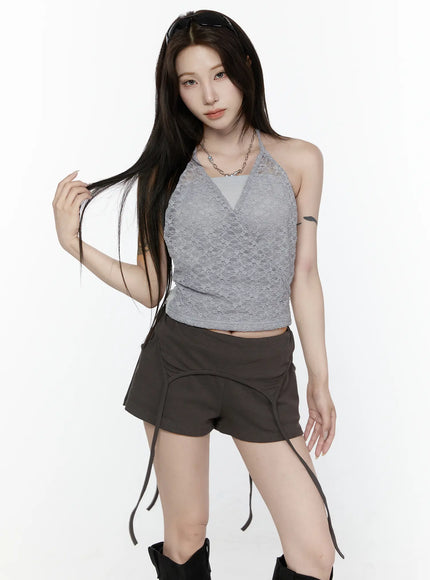 Lace Halter-Neck Top IL522 Gray upper-body front shot model touching hair wearing gray lace wrap halter top with chain necklace and dark mini shorts styling