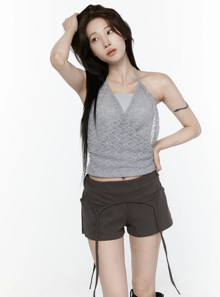 Lace Halter-Neck Top IL522 Gray front shot model hand in hair gazing up wearing gray lace wrap crop halter top with dark mini shorts on white background